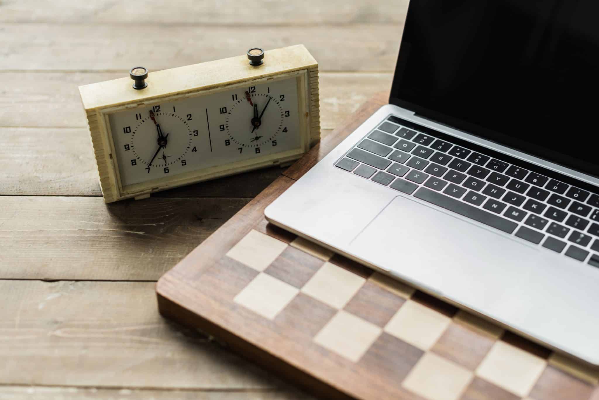 A laptop computer sitting on top of a wooden table